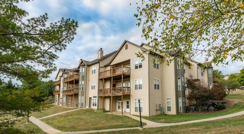a large house with trees and grass