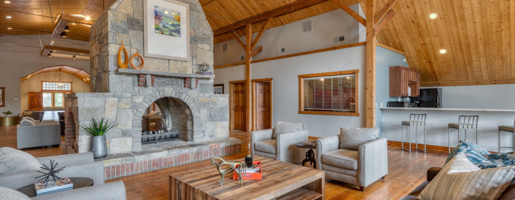 Lodge-style clubhouse with wood ceilings and a fireplace